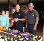 Three people hand out treats at the Monster Mash Event