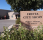 a brick sign that reads, Fruita City Shops, Public Works and Parks